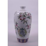 A Chinese polychrome enamelled porcelain vase decorated with fruiting peach branches, bats and