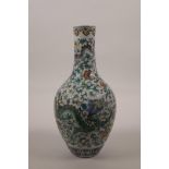 A Chinese doucai porcelain bottle vase decorated with dragons amongst flowers, seal mark to base,