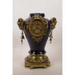 A blue glazed porcelain mantel clock, with gilt metal mounts and ram's mask decoration, with gilt