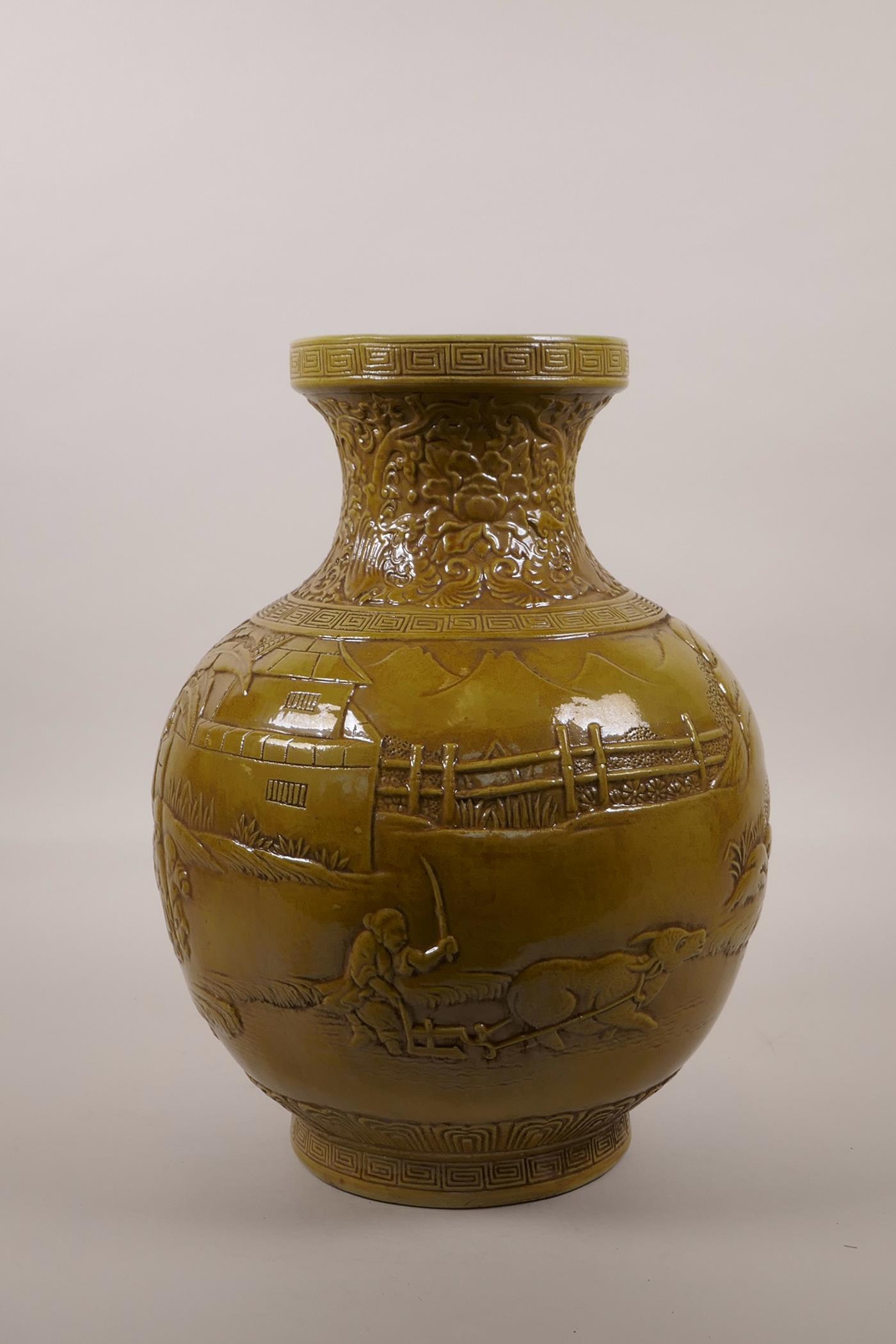 A large Chinese ochre glazed pottery vase with raised decoration of everyday village life, impressed - Image 2 of 5