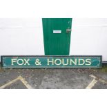 A gilt and reverse painted glass pub sign, Fox and Hounds, A/F, glass cracked, 18" x 138"