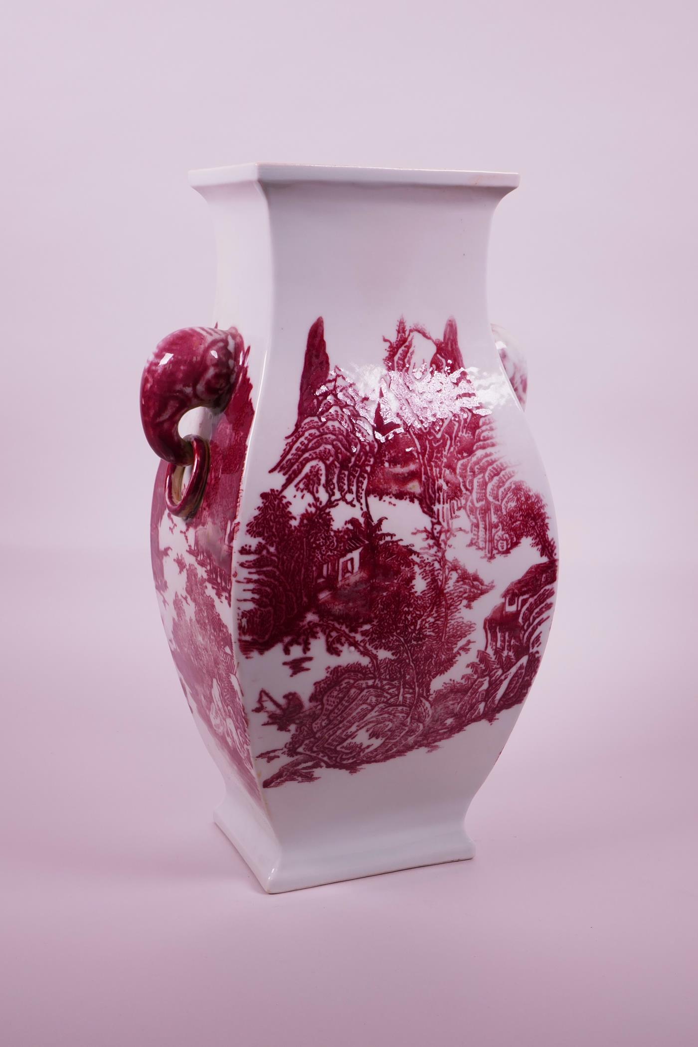 A large Chinese red and white porcelain vase with two elephant head handles, decorated with