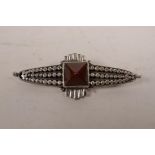 A 925 silver Art Deco style brooch set with a central inset red stone, 2½" wide