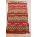 A hand woven wool tribal rug, 33" x 51"