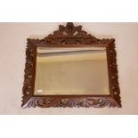 A C19th French carved oak cushion wall mirror, with original bevelled glass plate and carved lion