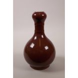 A Chinese garlic head vase with a sang de boeuf glaze, 6 character mark to base, 9" high