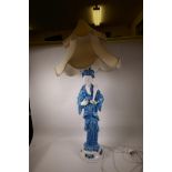 A large ceramic table lamp in the form of a Chinese sage in blue robes, with two tier pagoda