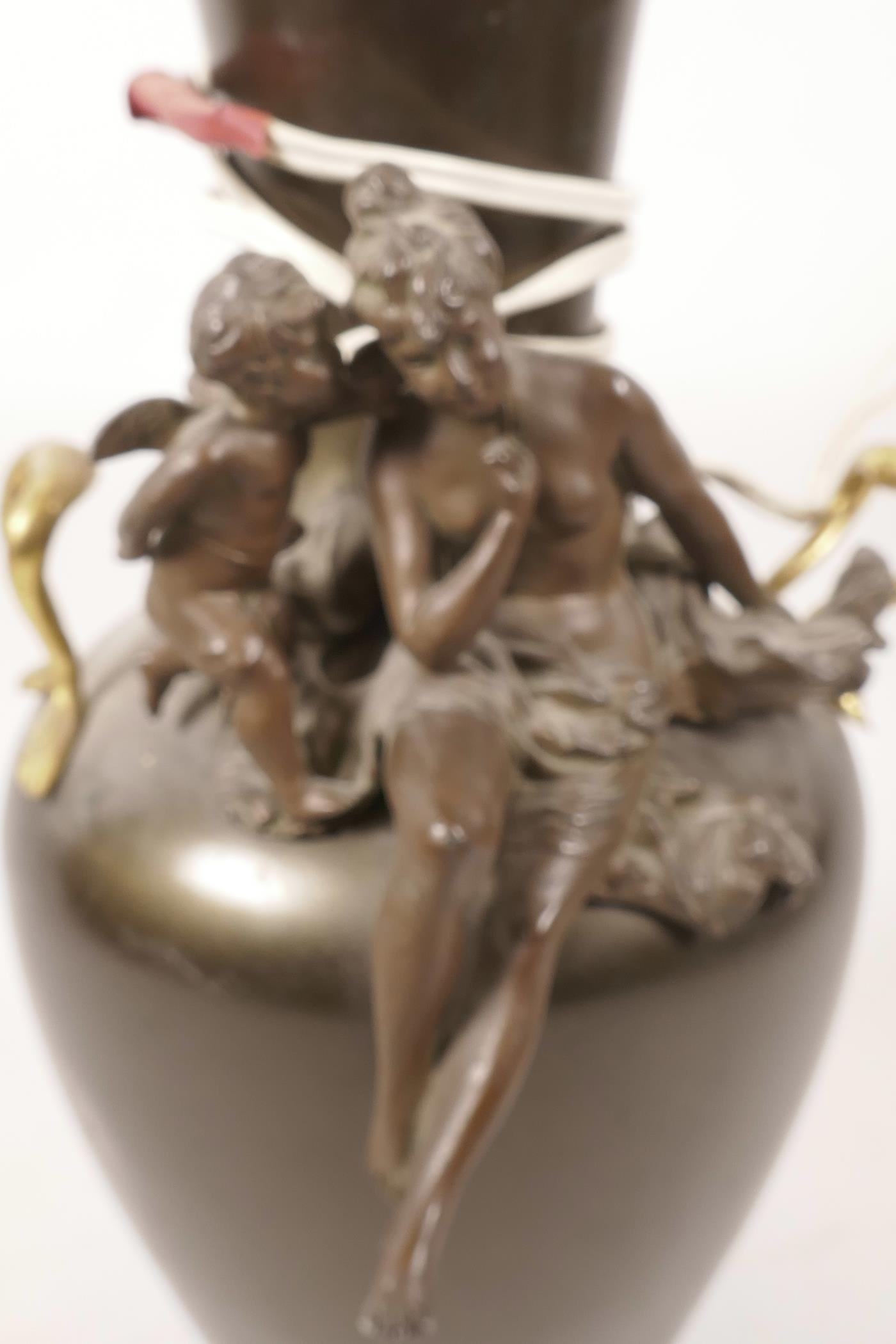 A bronzed table lamp, the two handled vase shaped body with applied decoration of a semi clad lady - Image 2 of 2