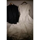 A white satin wedding dress from Marshall and Snelgrove, and a Christian Dior blue pin striped suit