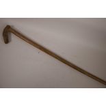 A vintage walking stick, the wooden handle carved as a horse's head, 33" long