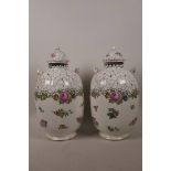 A pair of Continental porcelain baluster vases and covers decorated with roses, marked Sevres,