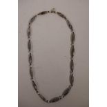 A banded agate beaded necklace with lozenge shaped beads, 25½" long