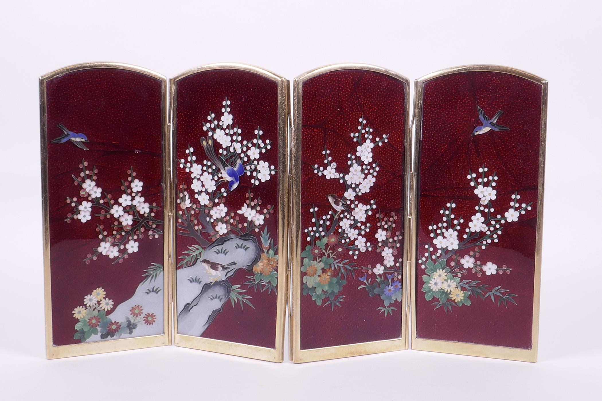 A Japanese red Ginbari cloisonné four fold table screen decorated with birds amongst prunus blossom,