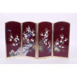 A Japanese red Ginbari cloisonné four fold table screen decorated with birds amongst prunus blossom,