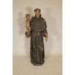 A C19th carved and painted pine figure of St Joseph with the Christ Child, 52" high