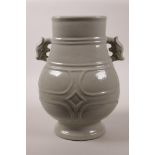 A Chinese grey glazed pottery vase with two dragon head handles, 11" high, A/F