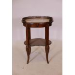 A Colonial hardwood two tier occasional table in the French style, with single drawer and inset