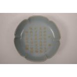 A Chinese duck egg blue crackle glazed porcelain dish with lobed rim and chased and gilt character