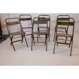 A matched set of six metal folding chairs