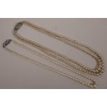 A two string graduated pearl necklace with sterling silver clasp, 17" long, together with a single