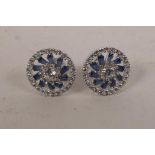 A pair of silver, cubic zirconium and sapphire set stud earrings, ½" diameter