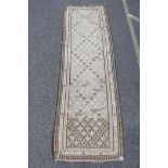 An Afghan Kilim runner with all over decoration in a cream, beige and brown palette, 37" x 43"