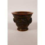 A Chinese faux horn libation cup with two carved handles in the form of kylin, impressed mark to