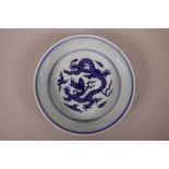 A Chinese blue and white porcelain dish with steep sides, decorated with a dragon in flight, 6
