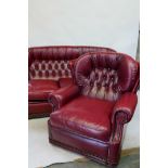 A three piece suite in button back red leather, settee 72" wide