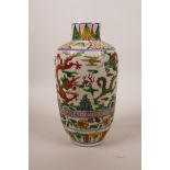 A Chinese wucai porcelain vase decorated with dragons chasing the flaming pearl, 6 character mark to