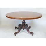 A Victorian burr walnut oval top loo table raised on a carved column pedestal, on four swept