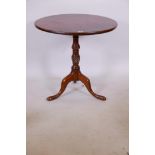 A Georgian mahogany occasional table with a fixed top on a turned and carved column and tripod