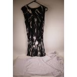 A Karen Millen black sleeveless dress with white white leaf printed decoration, size 10, together