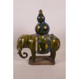 A Chinese Tang style pottery elephant with a green and blue drip glaze, 10½" long, 13" high