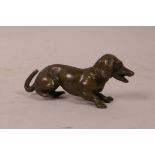 A bronzed lead miniature figure of a dachshund, 2" long