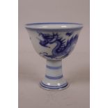 A Chinese blue and white porcelain stem cup decorated with a dragon chasing the flaming pearl, 6