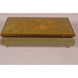 A vintage Italian lacquered wood bombe shaped musical jewellery box on four brass feet, 10" x 5" x