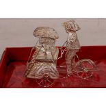 A Chinese silver wire model of a rickshaw and rider, 2½" long (cased)