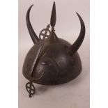 A C19th Indo-Persian steel helmet with horns and embossed eyes