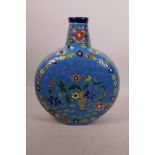 An Oriental polychrome porcelain flask with floral enamel decoration on a blue ground, 10½" high