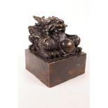 A large Chinese filled bronze seal with a dragon surmount, 4" x 4" x 4½"