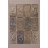 A set of twelve Chinese white metal scroll weights depicting the animals of the Zodiac, 2" x 4"