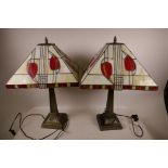 A pair of Tiffany style lamps with Egyptianesque square section columns and bases, with leaf