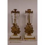 A pair of French gilt bronze and marble candlesticks in the form of flower baskets with glass lustre