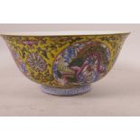 A Chinese porcelain bowl decorated with exotic creatures in bright enamels on a floral decorated