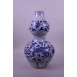 A Chinese blue and white pottery double gourd vase decorated with lotus flowers and kylin, 13½" high