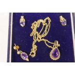 A 9ct gold and amethyst on a fine chain, together with a pair of similar stone set earrings and