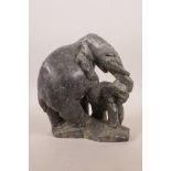 An African stone carving of an elephant and calf, carved signature to base, 7" high