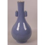 A Chinese blue glazed porcelain vase with lug handles, 10" high