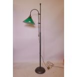 An antiqued brass adjustable standard lamp with glass shade, 64" high